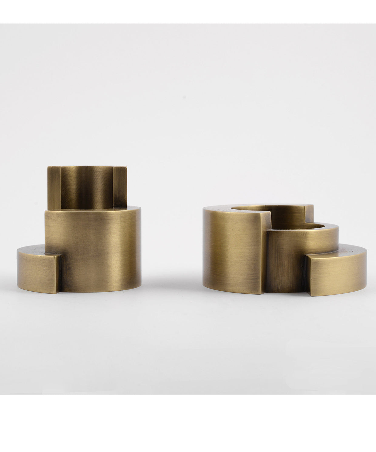 Two brass cylindrical objects on a white background