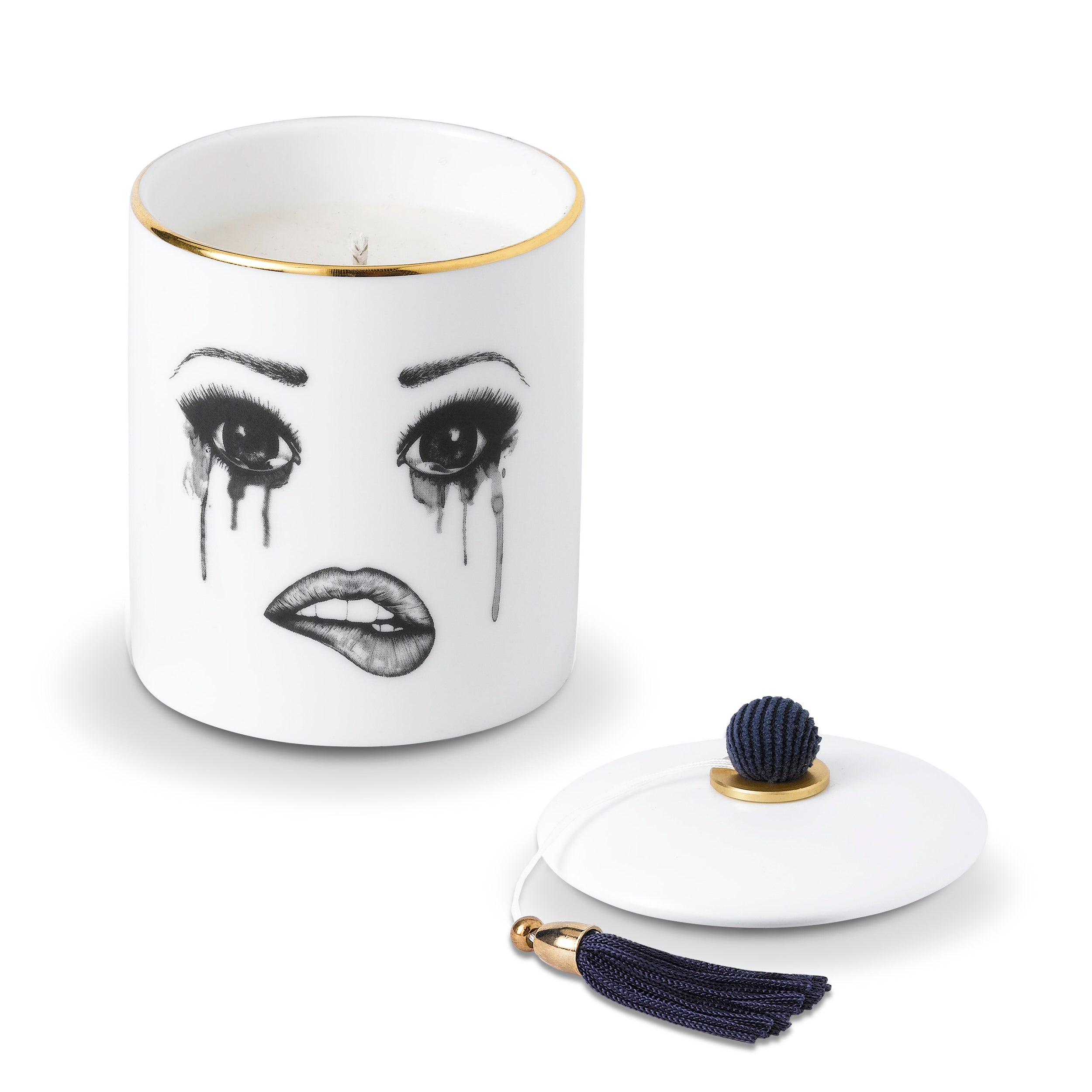 Candle with face design and matching lid on a white background