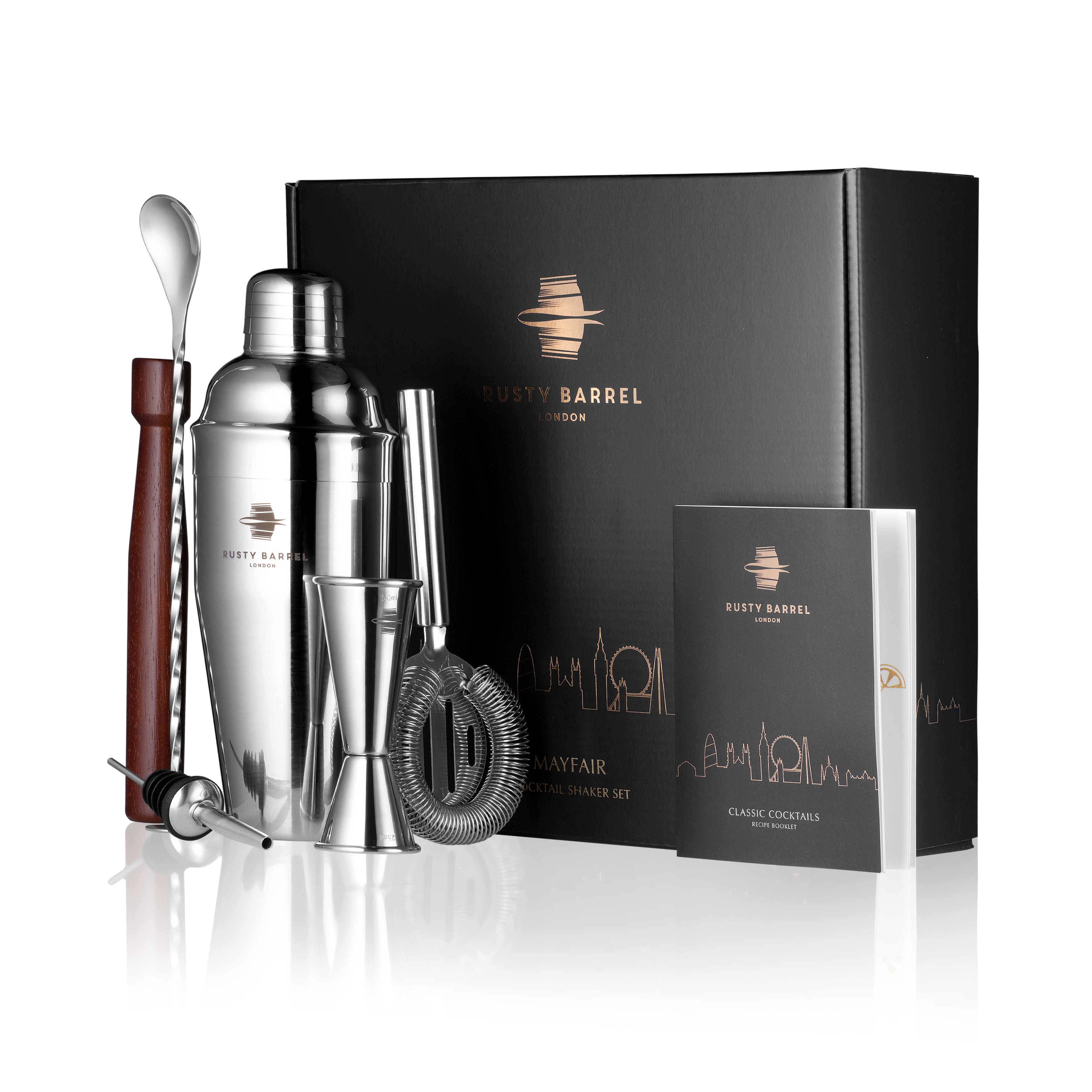 Bartender kit with shaker, jigger, and spoon in front of a Fusty Barrel box on a white background