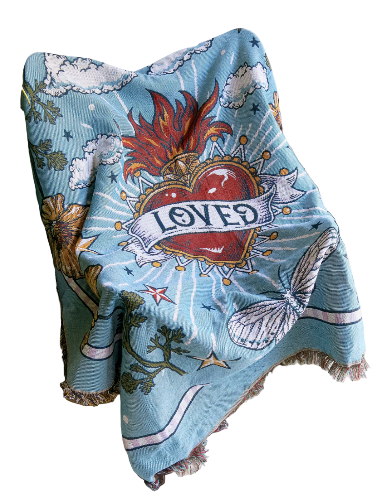 Decorative blanket with a heart design and 'LOVED' text draped over a chair.