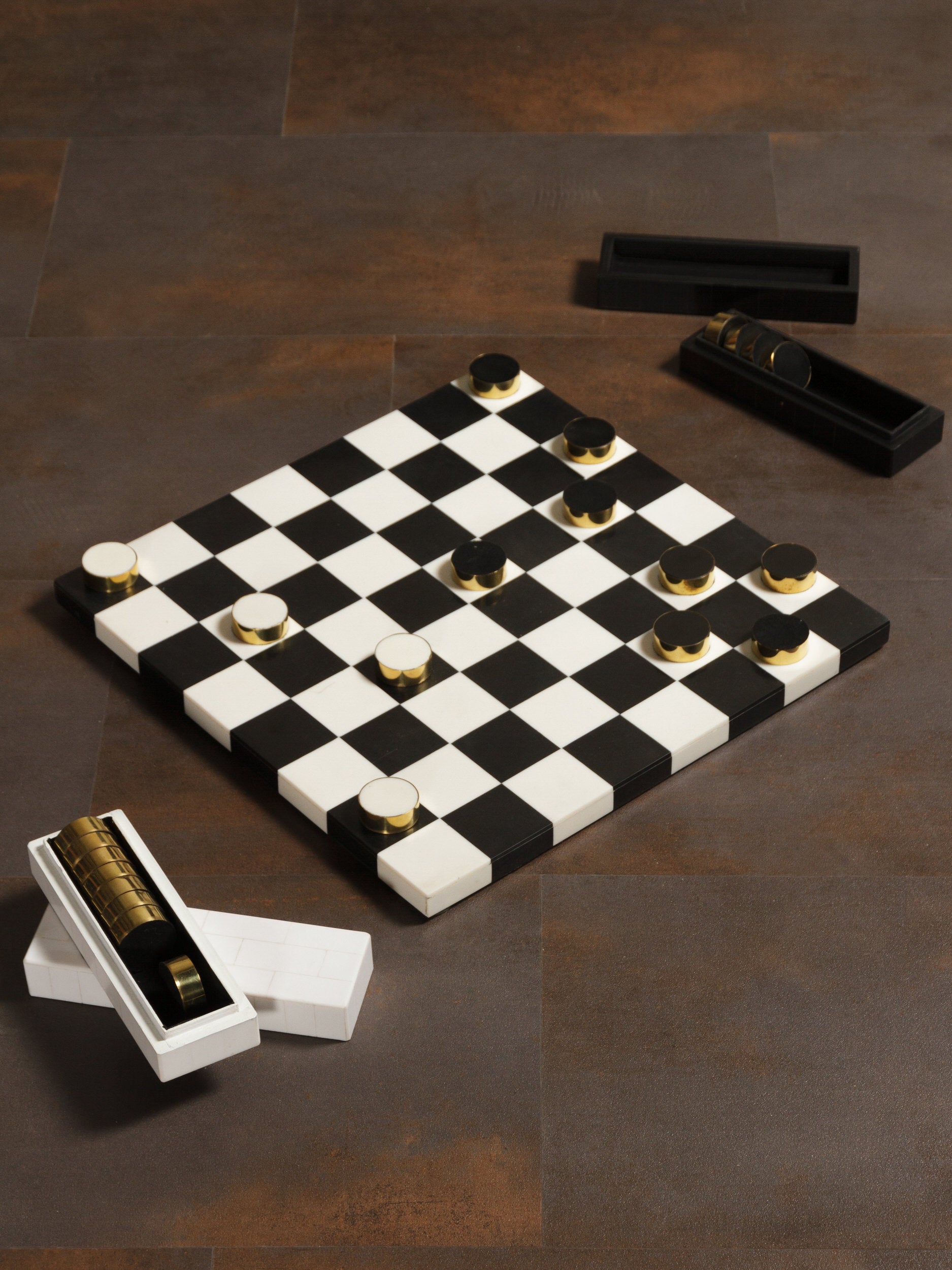 Checkered game board with pieces on a brown surface