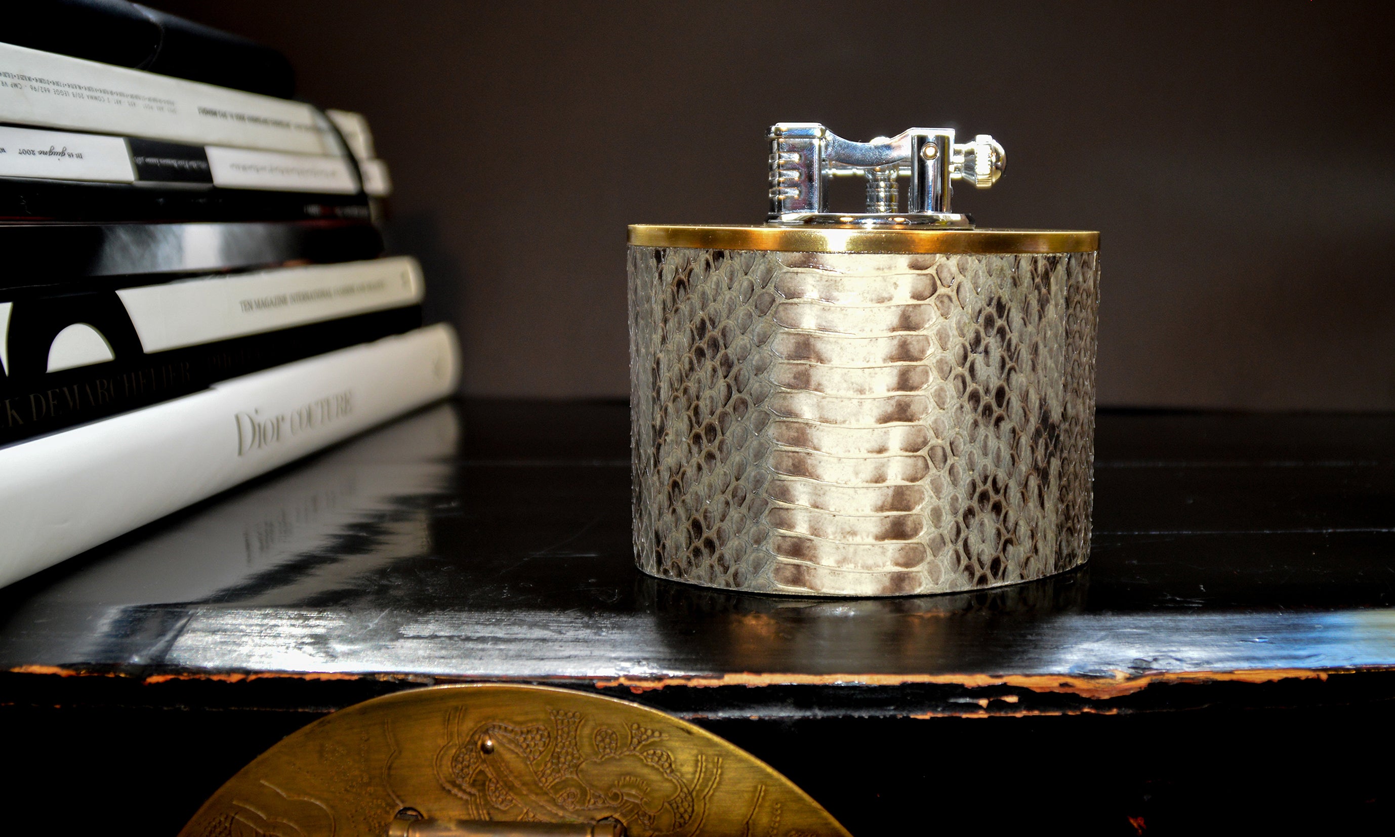 Decorative lighter with textured surface on a reflective surface