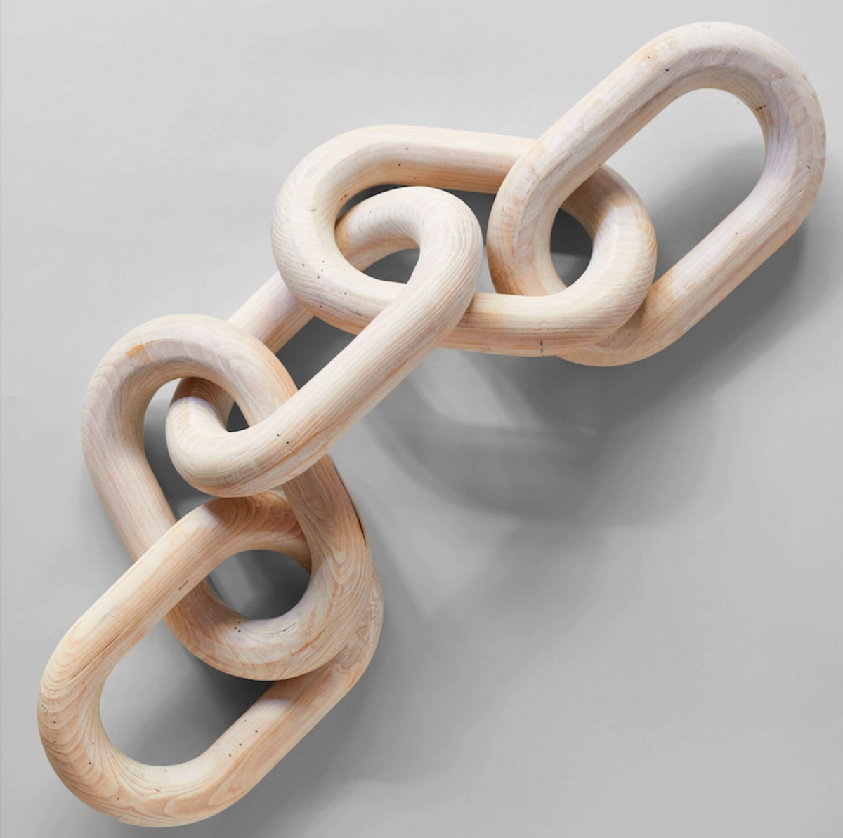 Wooden chain toy on a light gray background