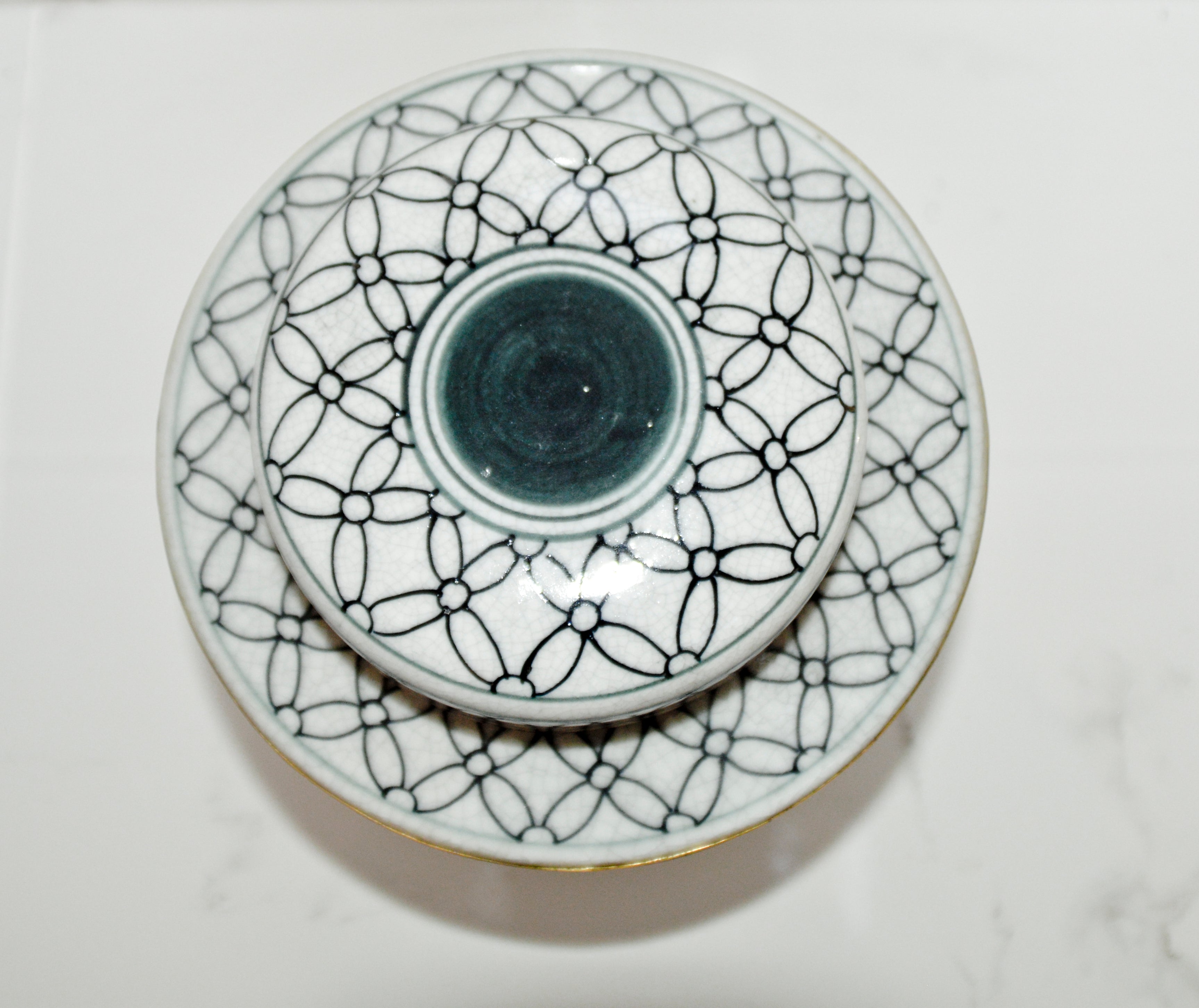 Ceramic plate with geometric black pattern on a white background