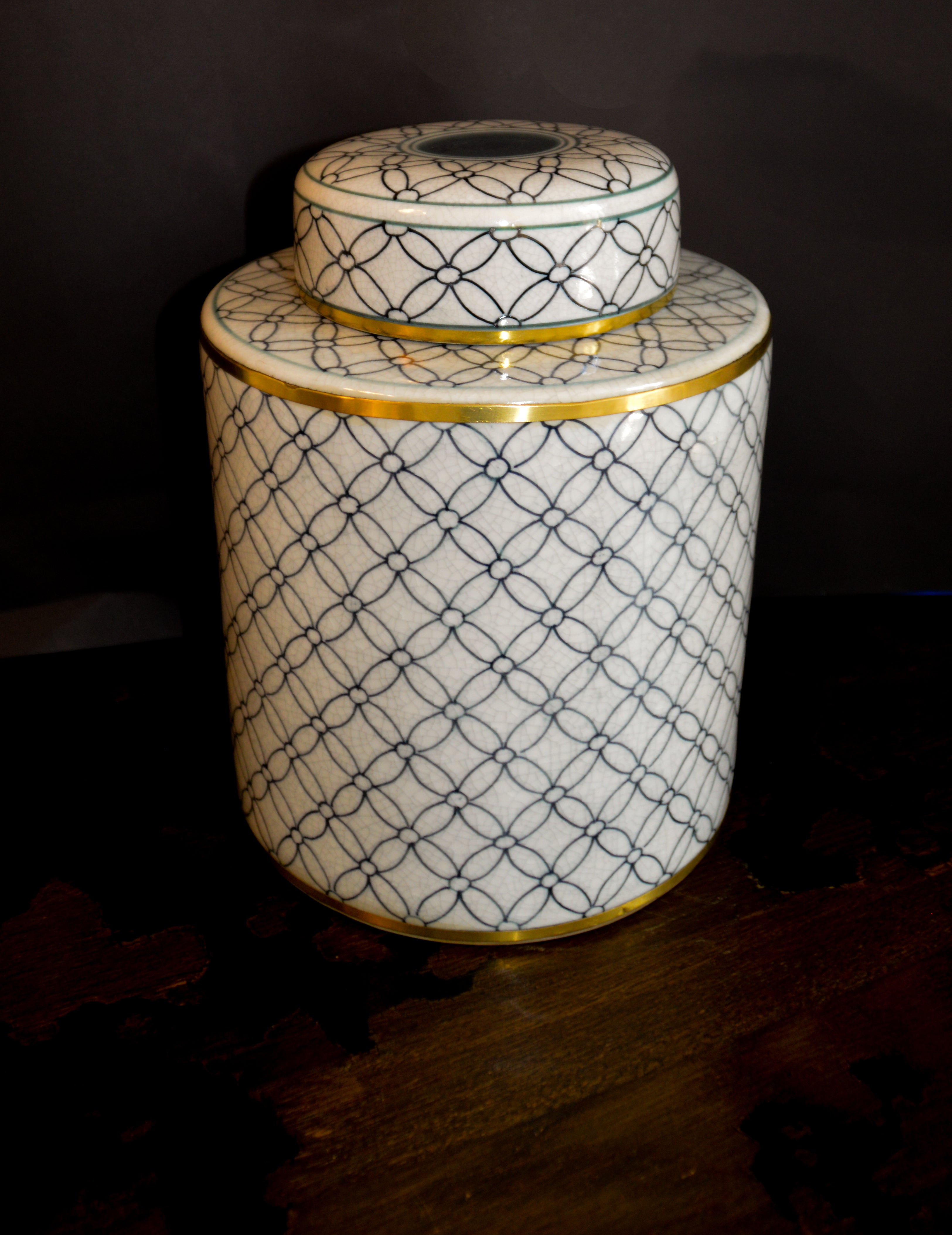 Decorative ceramic jar with geometric pattern on a dark background