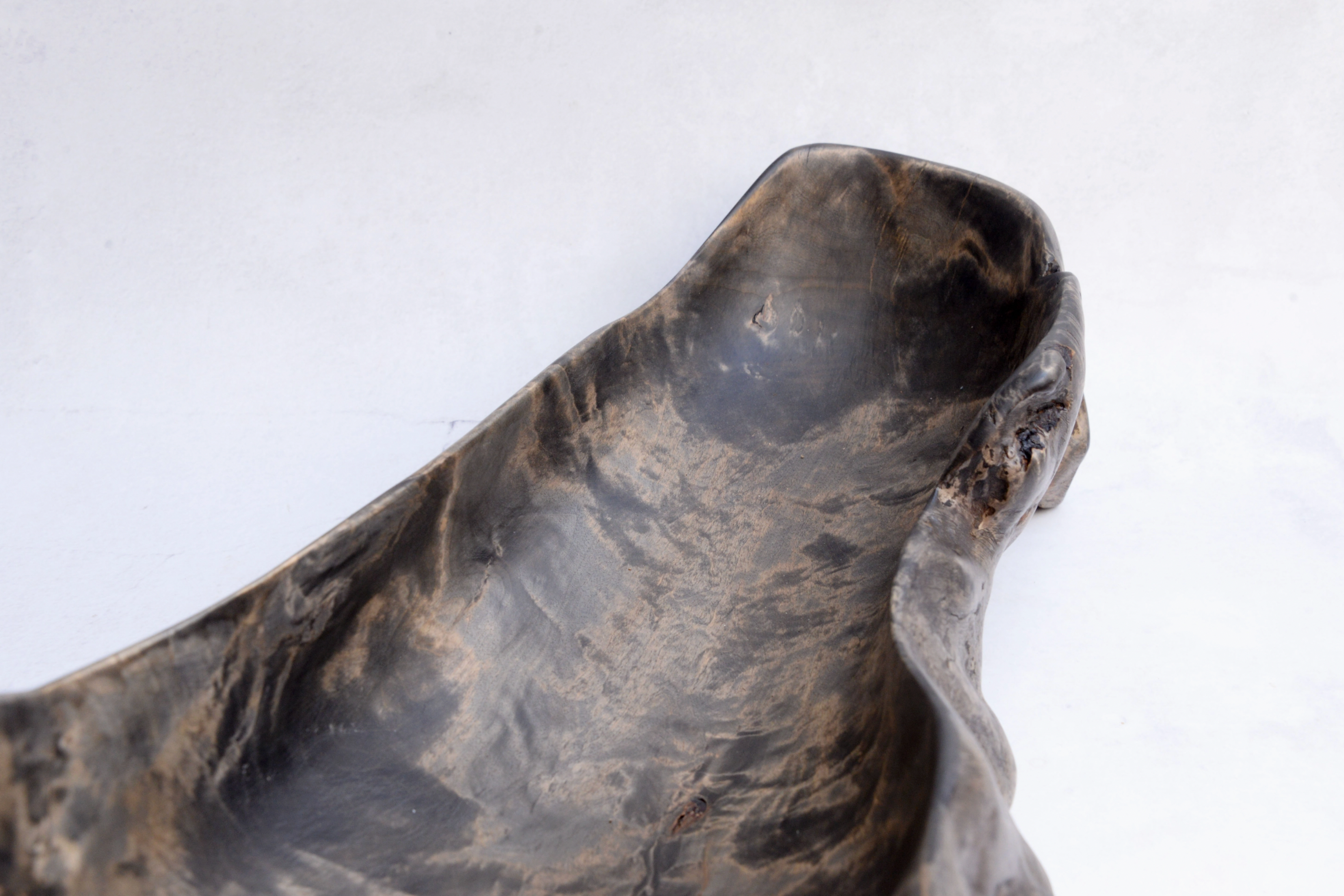 Close-up of a textured stone bowl on a white background