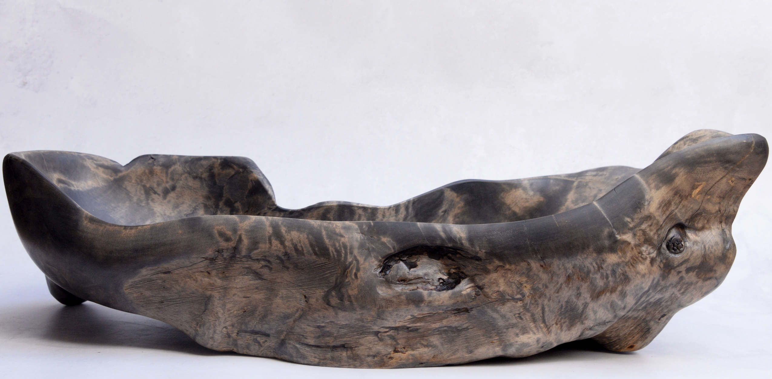 Wooden seal-shaped bowl on a white background