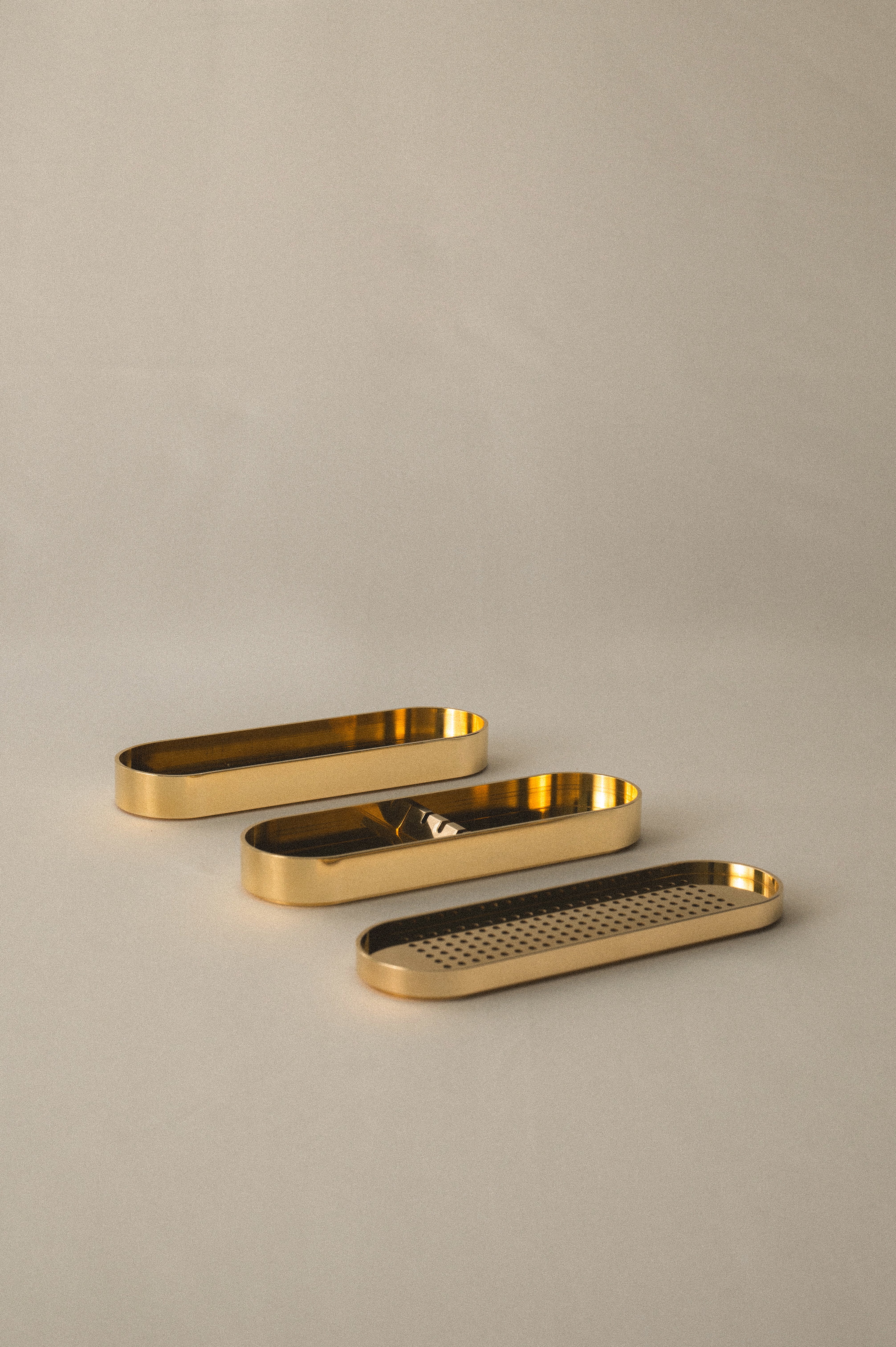 Brass Incense Burner .Three gold metal trays of different shapes on a beige background
