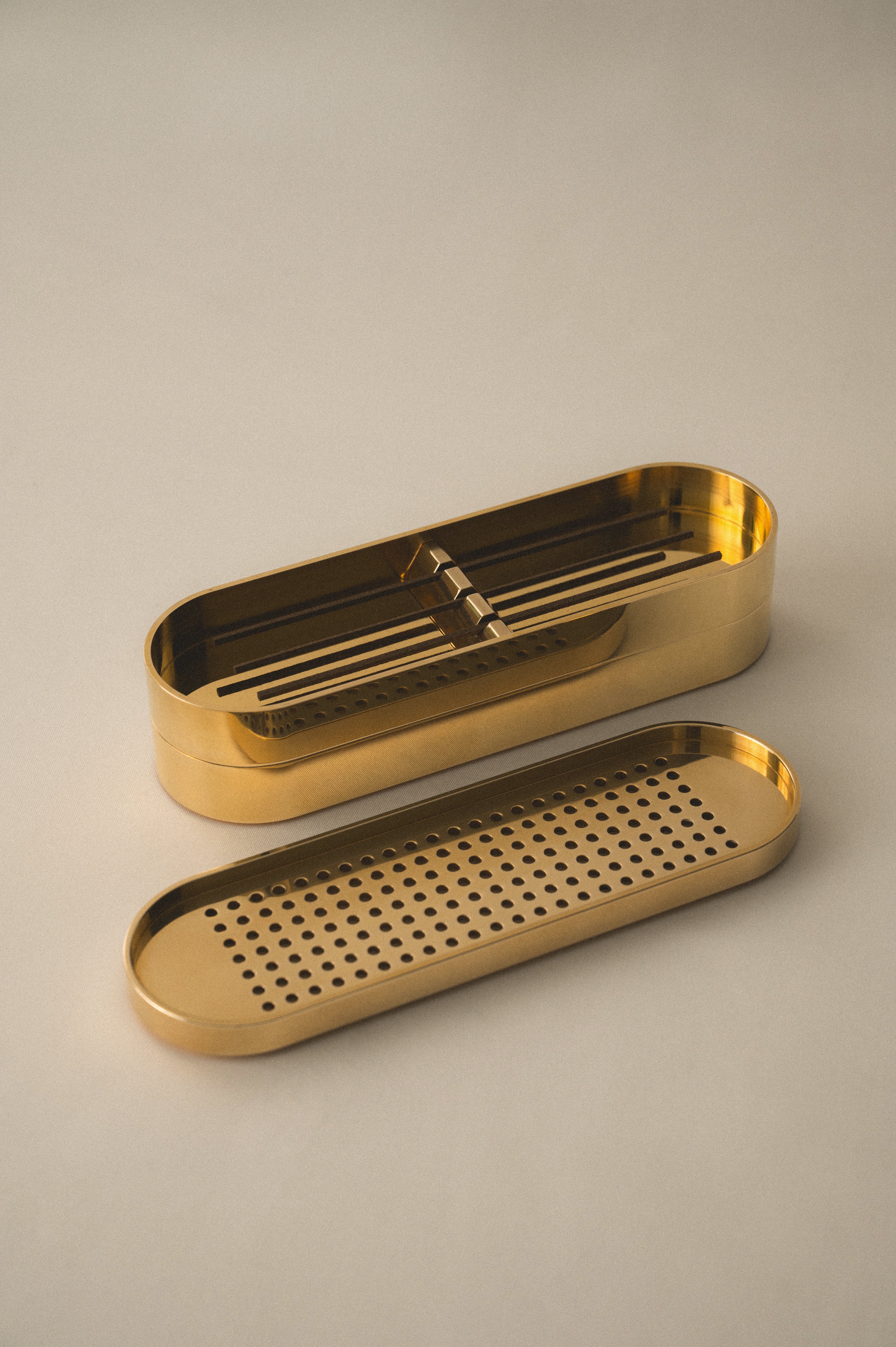 Brass Incense Burner . Two gold metal trays on a beige background