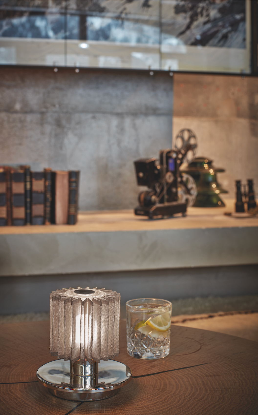 Glass with lemon on a table next to a decorative object in a room setting