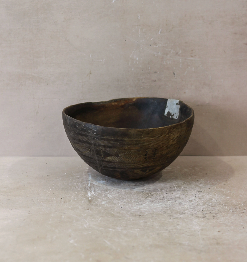 Wooden bowl on a beige surface with a neutral background