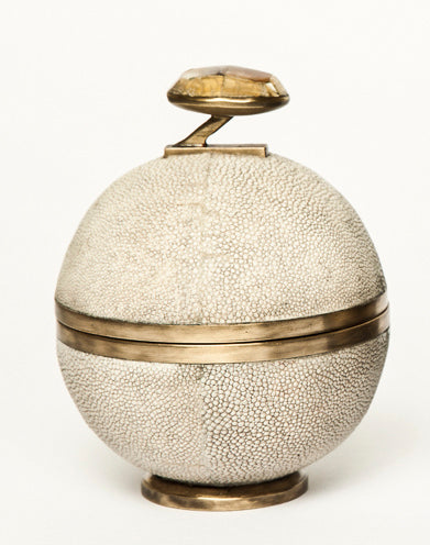 Decorative spherical box with shagreen finish and gold accents on a white background