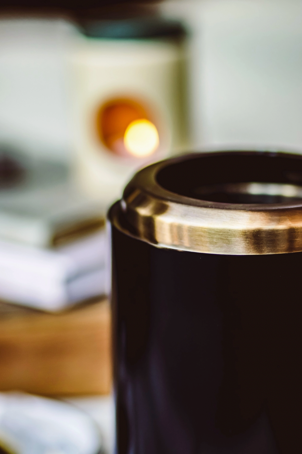 Black cylindrical object with metallic top on a blurred background