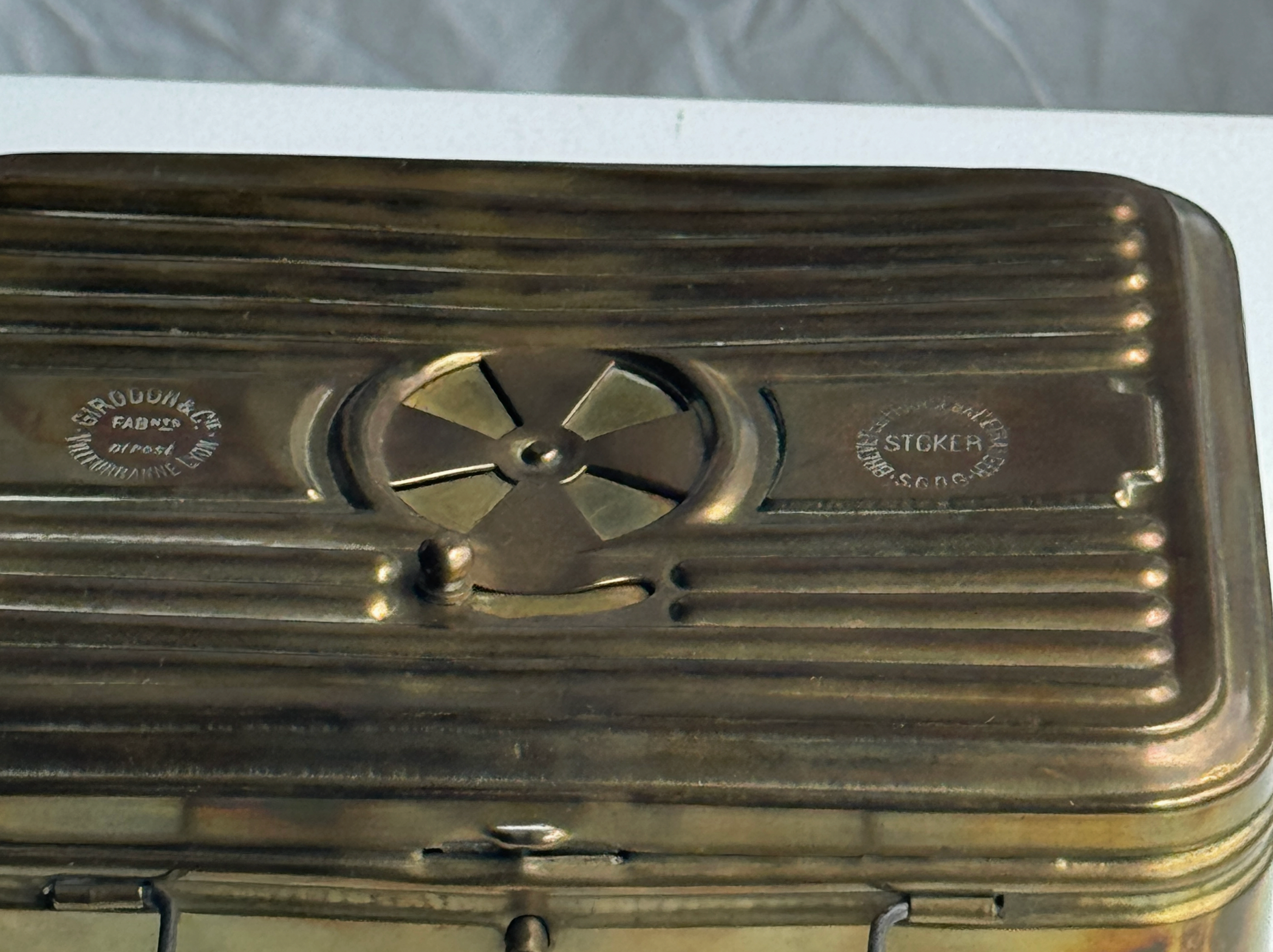 Metallic engine block with 'Stokes' branding on a white background