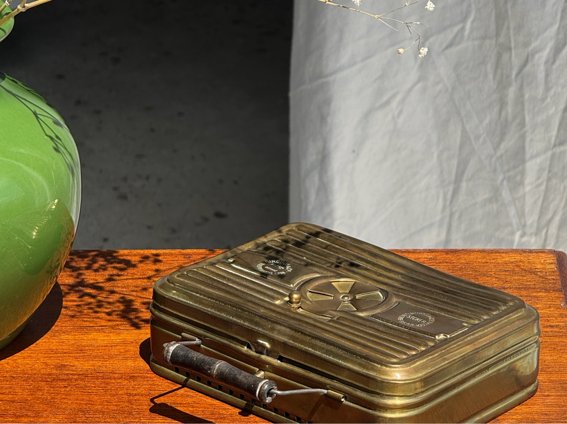 Vintage-style brass box with a radioactive symbol on a wooden surface