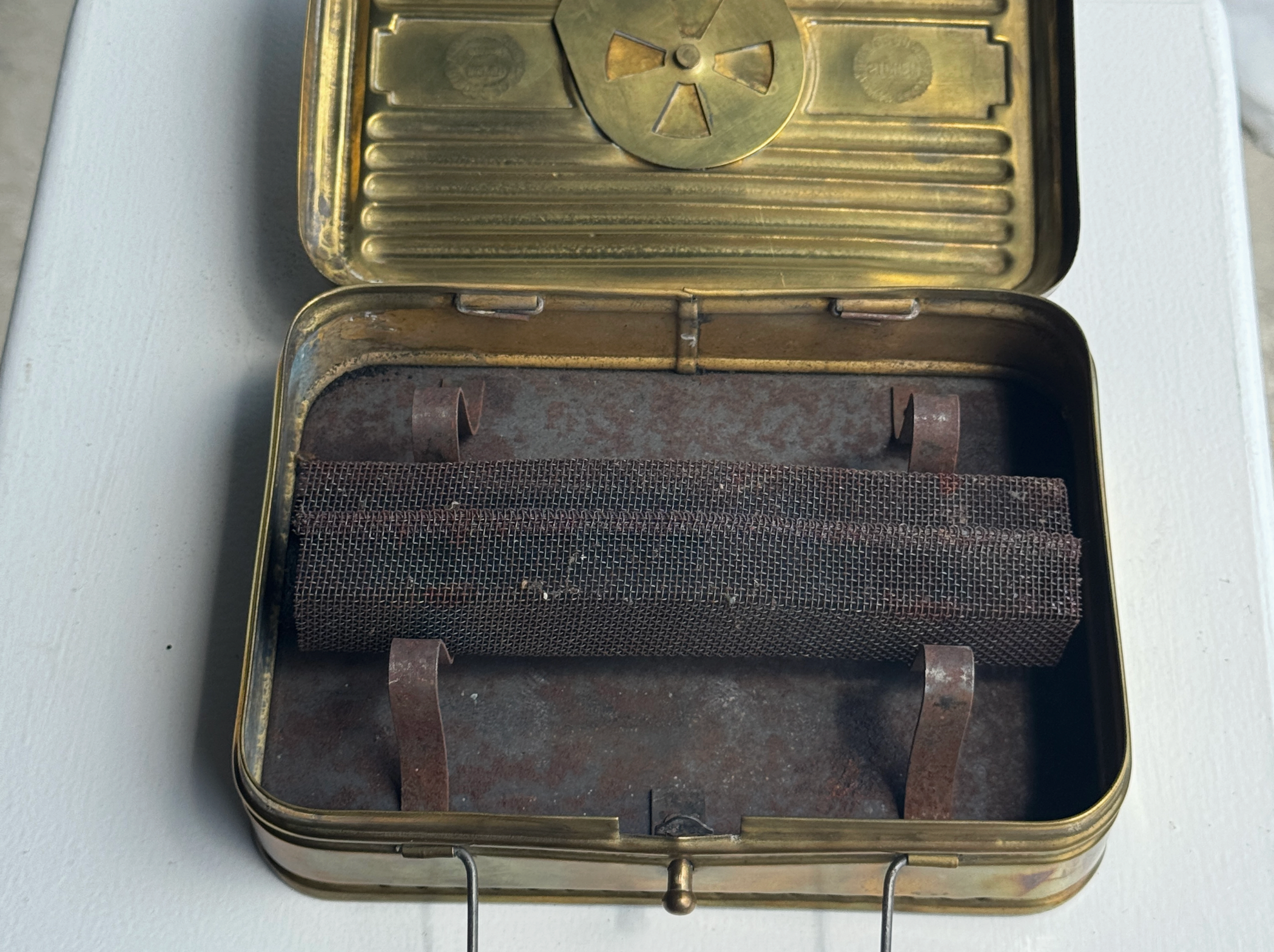 Vintage metal canister with a cylindrical mesh filter inside, on a white background