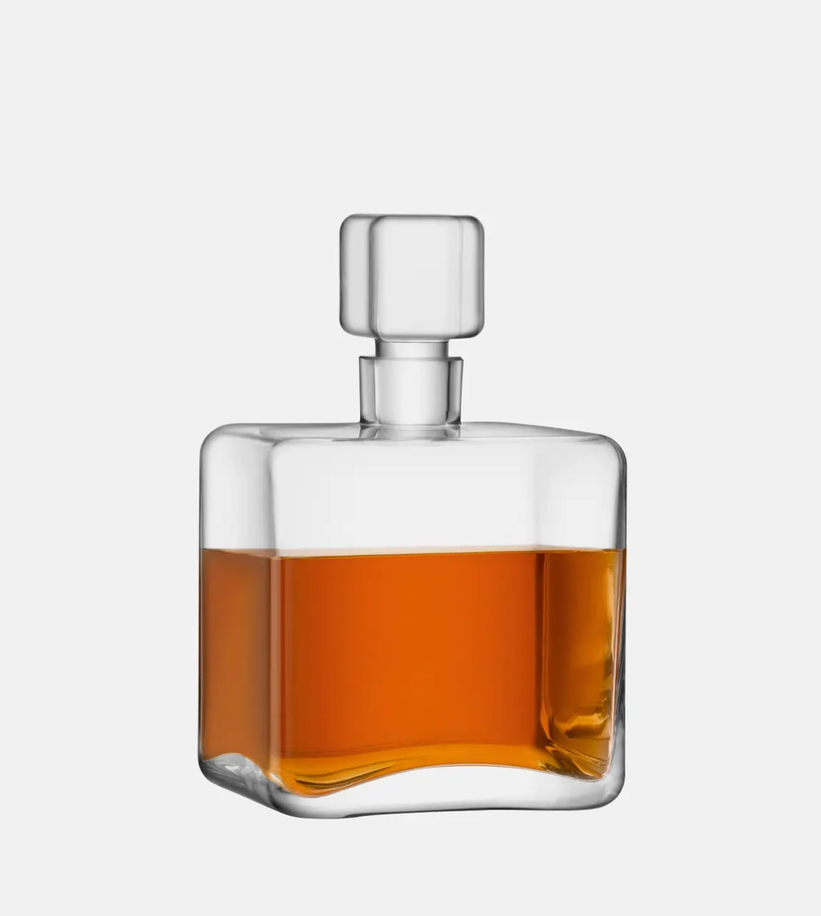 Glass whiskey decanter with a clear liquid on a white background
