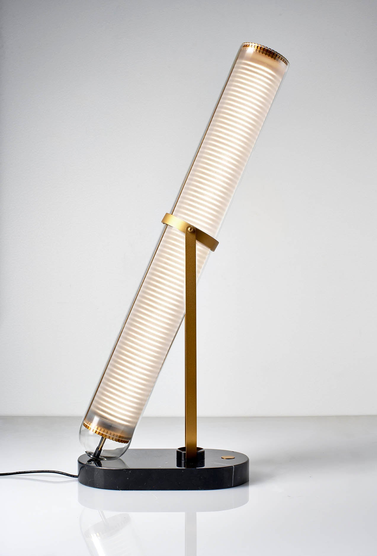 Modern table lamp with cylindrical design on a white background