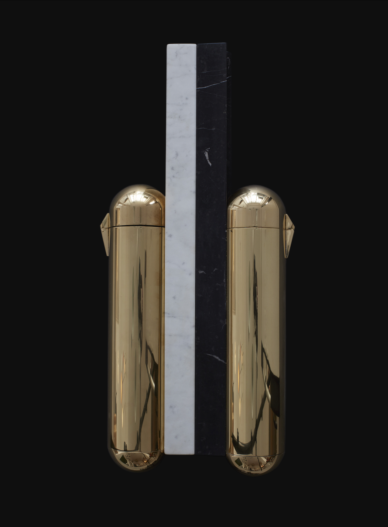 Two gold-colored door handles on a black background with a ruler for scale.