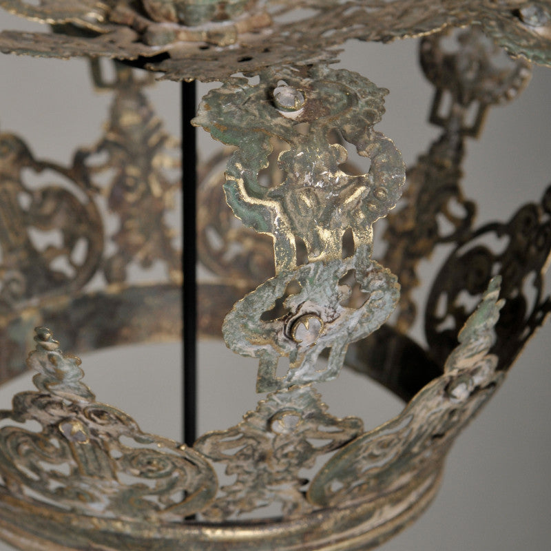 Close-up of an ornate metal object with intricate designs on a neutral background