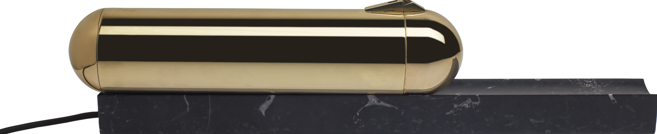 Gold cylindrical object on a black marble surface