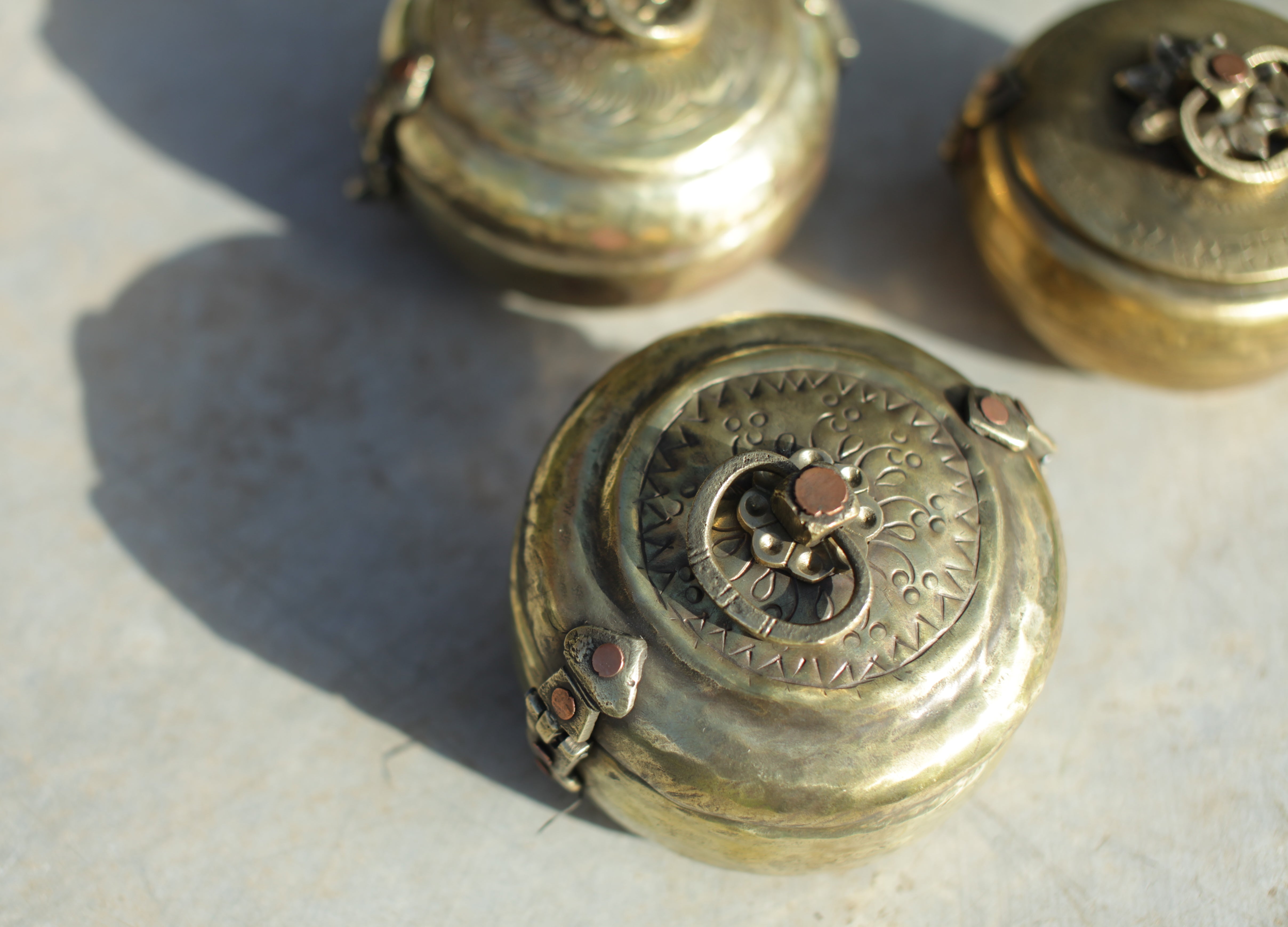 Close-up of ornate metal objects on a textured surface