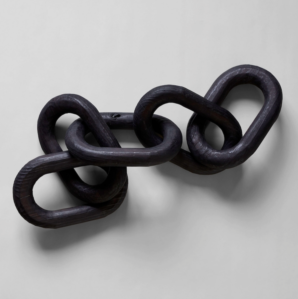 Black metal chain on a light gray background