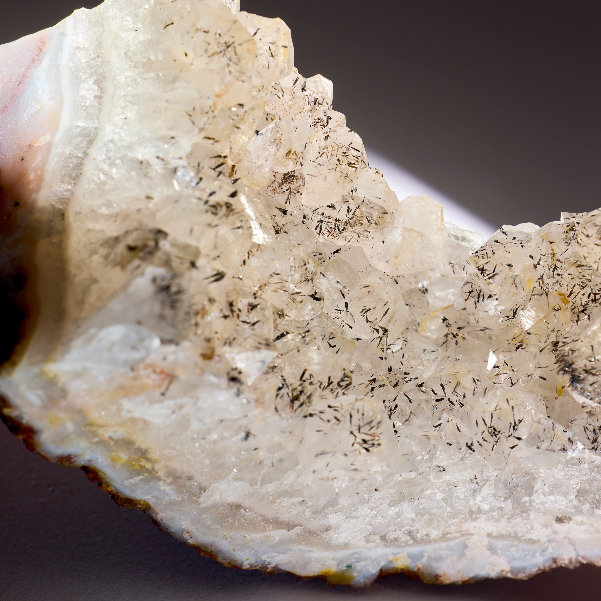 Close-up of a crystal formation with visible crystals on a dark background