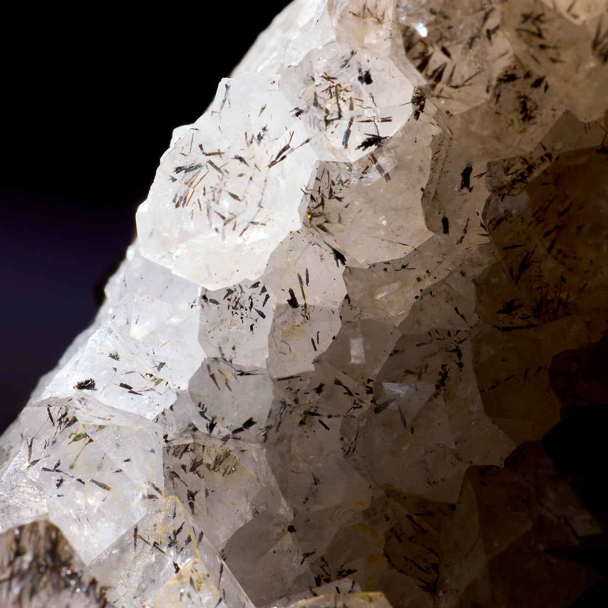 Close-up of a crystal formation with visible minerals on a dark background